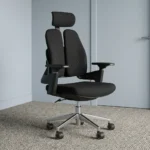 Dual back orthopedic office chair featuring an ergonomic split twin-backrest design in black upholstery, an adjustable curved headrest, padded black fabric seat cushion, adjustable T-shaped armrests, pneumatic tilt and height adjustment mechanism, and a polished aluminum five-star swivel base on dual-wheel casters.