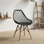 Black plastic Eames-style chair featuring a molded seat with an open diamond-lattice backrest, a solid black seat pad, and natural wooden dowel legs with black metal wire Eiffel bracing.