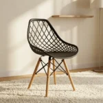 Black plastic Eames-style chair featuring a molded seat with an open diamond-lattice backrest, a solid black seat pad, and natural wooden dowel legs with black metal wire Eiffel bracing.