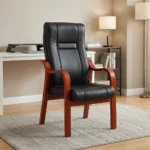 High-back executive visitors chair featuring plush black leatherette upholstery with stitched paneling, ergonomic lumbar and back support, padded seat cushion, and a sturdy solid wood frame with warm mahogany-finished curved armrests and four fixed legs.