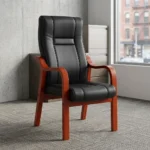 High-back executive visitors chair featuring plush black leatherette upholstery with stitched paneling, ergonomic lumbar and back support, padded seat cushion, and a sturdy solid wood frame with warm mahogany-finished curved armrests and four fixed legs.