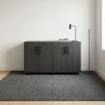 4-door wooden office cupboard featuring a dark charcoal grey wood grain finish, four hinged swing doors with sleek black vertical handles, a low-profile credenza silhouette, internal divided shelving units, and a mobile base equipped with heavy-duty caster wheels.