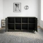 4-door wooden office cupboard featuring a dark charcoal grey wood grain finish, four hinged swing doors with sleek black vertical handles, a low-profile credenza silhouette, internal divided shelving units, and a mobile base equipped with heavy-duty caster wheels.
