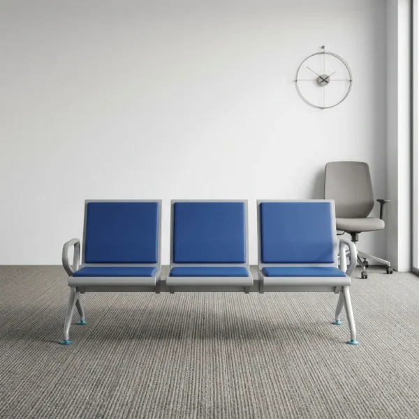 Heavy duty blue waiting bench featuring a 3-seater design with cushioned royal blue leatherette seat and back pads, a silver powder-coated steel frame, integrated side armrests, and a sturdy beam structure supported by slanted legs with leveling glides.