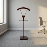 Modern wooden office coat hanger featuring a rich mahogany-finished wood construction, a contoured upper jacket hanger supported by metallic V-struts, a horizontal trouser bar, and a sturdy square base.
