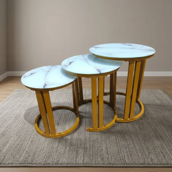 Marble top nest stools featuring a 3-piece set with white faux marble circular tops, distinctive dark veining details, and elegant metallic gold-finished metal frames with open semi-circular base supports.