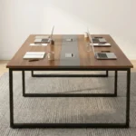 2.4 meters office boardroom table featuring a rich walnut wood laminate top, a central grey inset strip with pop-up power cable access modules, and sturdy black metal square loop legs.