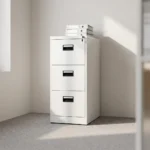 Steel 3 drawer office cabinet featuring a clean white powder-coated metal finish, three full-extension filing drawers with recessed black handles, label holders, and a top central locking mechanism.