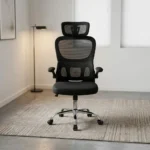 Ergonomic chair with flip armrests featuring a breathable black mesh backrest, an adjustable mesh headrest, integrated lower lumbar support cushion, padded fabric seat, 90-degree flip-up padded armrests, height adjustment lever, and a chrome five-star swivel base with caster wheels.
