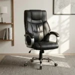 Black leather office chair featuring high-density black leather upholstery with contrast amber/orange stitching, a high backrest with an integrated headrest cushion, padded silver curved armrests, a height adjustment lever, and a polished chrome five-star swivel base with caster wheels.