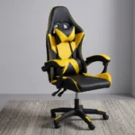 Ergonomic yellow gaming chair featuring high-density black and vibrant yellow faux leather upholstery with a geometric star/X pattern, a high-back racecar-style design, removable headrest cushion and lumbar pillow, padded link armrests, pneumatic tilt/height control levers, and a five-star nylon swivel base with color-accented caster wheels.