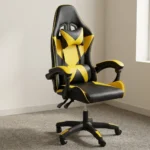 Ergonomic yellow gaming chair featuring high-density black and vibrant yellow faux leather upholstery with a geometric star/X pattern, a high-back racecar-style design, removable headrest cushion and lumbar pillow, padded link armrests, pneumatic tilt/height control levers, and a five-star nylon swivel base with color-accented caster wheels.