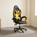 Ergonomic yellow gaming chair featuring high-density black and vibrant yellow faux leather upholstery with a geometric star/X pattern, a high-back racecar-style design, removable headrest cushion and lumbar pillow, padded link armrests, pneumatic tilt/height control levers, and a five-star nylon swivel base with color-accented caster wheels.