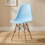 High quality Eames chair featuring a light blue molded polypropylene seat shell, natural solid wood dowel legs, and Eiffel-style black wire metal cross-bracing.