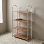 Free standing shoe rack featuring four light wood-grain open shelves, a white powder-coated tubular steel frame with arched side handles, wire side guardrails, and rear X-brace cross-support.