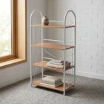 Free standing shoe rack featuring four light wood-grain open shelves, a white powder-coated tubular steel frame with arched side handles, wire side guardrails, and rear X-brace cross-support.