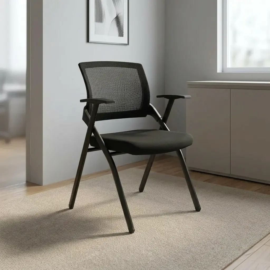 Ergonomic mesh foldable chair featuring a breathable black mesh backrest, contoured padded fabric seat, fixed T-style armrests, and a space-saving foldable black powder-coated steel frame.