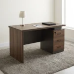 Advanced 140cm executive desk featuring a dark walnut wood-grain desktop with built-in cable grommet, floating-top aesthetic, integrated dark grey modesty panel with horizontal silver metallic trim lines, and a side-mounted pedestal containing three lockable storage drawers.