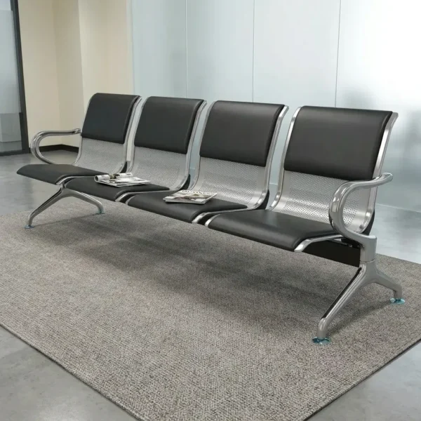 4-link padded waiting bench featuring four connected ergonomically contoured seats with perforated silver metal shells, black PU leather seat cushion and backrest pads, polished chrome armrests at each end, a central steel support beam, and heavy-duty chrome leg stands with leveling feet.