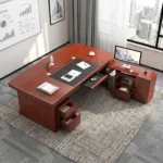 160cm executive office table featuring a rich mahogany wood finish, integrated black leatherette writing inlay, built-in cable management ports, decorative front modesty panel with geometric dark charcoal inlay and center diamond motif, and an L-shaped side return credenza with lockable storage drawers and open shelving.