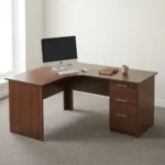 1.6m curved desk with drawers featuring a rich dark mahogany wood-grain finish, ergonomic L-shaped curved corner work surface, integrated cable management grommet, matching modesty panels, and a built-in right-hand storage pedestal with three drawers, straight silver handles, and a top-drawer key lock.