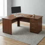 1.6m curved desk with drawers featuring a rich dark mahogany wood-grain finish, ergonomic L-shaped curved corner work surface, integrated cable management grommet, matching modesty panels, and a built-in right-hand storage pedestal with three drawers, straight silver handles, and a top-drawer key lock.