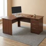 1.6m curved desk with drawers featuring a rich dark mahogany wood-grain finish, ergonomic L-shaped curved corner work surface, integrated cable management grommet, matching modesty panels, and a built-in right-hand storage pedestal with three drawers, straight silver handles, and a top-drawer key lock.