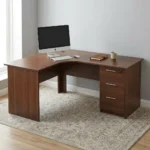 1.6m curved desk with drawers featuring a rich dark mahogany wood-grain finish, ergonomic L-shaped curved corner work surface, integrated cable management grommet, matching modesty panels, and a built-in right-hand storage pedestal with three drawers, straight silver handles, and a top-drawer key lock.