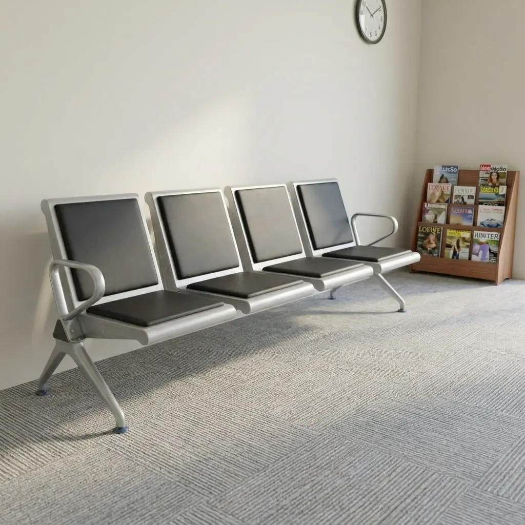 4-link heavy duty waiting bench featuring four connected seats with black padded leather cushions on seat and backrest panels, a durable silver powder-coated steel frame, side armrests, and angled legs with floor-protecting glides.