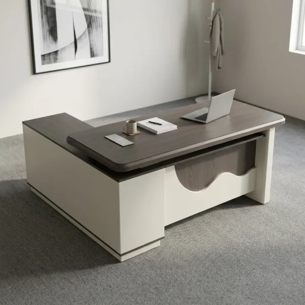 Spacious 1.6m office table featuring a two-tone grey wood-grain and cream laminate surface with rounded edges, a rectangular cable management outlet, an L-shaped side return credenza with open shelving and lockable drawers, and a decorative front modesty panel with a distinctive wave-pattern accent.