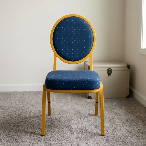 Armless blue conference chair featuring navy blue fabric upholstery with white dot pattern, a oval medallion backrest, a cushioned seat, and a stackable gold-finished metal frame with straight legs and floor glides.