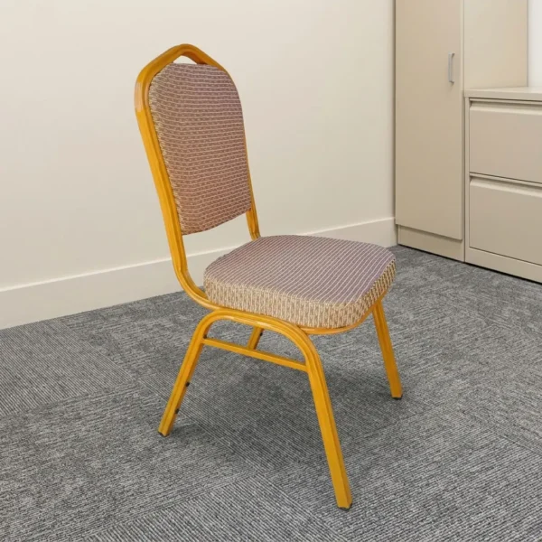 Brown stackable conference chair featuring patterned brown fabric upholstery on a thickly padded seat and rounded backrest, an ergonomic crown-top handle frame design, and a durable gold/yellow powder-coated steel frame with protective bumper guards and leg glides.