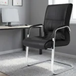 Black leather visitor seat featuring supple black leatherette upholstery with stitched paneling and plush padding, fixed armrests with black protective pads, and a polished chrome-finished cantilever sled base frame.