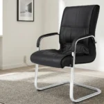 Black leather visitor seat featuring supple black leatherette upholstery with stitched paneling and plush padding, fixed armrests with black protective pads, and a polished chrome-finished cantilever sled base frame.