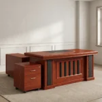 Executive 160cm office desk featuring a classic rich cherry wood-grain finish, a central black leatherette writing pad inlay, integrated cable grommets, a decorative front modesty panel with vertical black slats, an attached side return cabinet, and a matching mobile 2-drawer locking pedestal on casters.