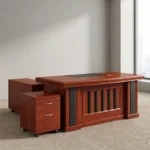 Executive 160cm office desk featuring a classic rich cherry wood-grain finish, a central black leatherette writing pad inlay, integrated cable grommets, a decorative front modesty panel with vertical black slats, an attached side return cabinet, and a matching mobile 2-drawer locking pedestal on casters.