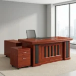 Executive 160cm office desk featuring a classic rich cherry wood-grain finish, a central black leatherette writing pad inlay, integrated cable grommets, a decorative front modesty panel with vertical black slats, an attached side return cabinet, and a matching mobile 2-drawer locking pedestal on casters.