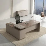 Managerial 1.4m office desk featuring a modern two-tone light walnut and taupe grey finish, an L-shaped layout with an integrated side return cabinet, an elevated desktop shelf with built-in cable management ports, and a full-length modesty panel.