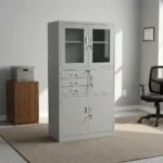 Steel cabinet with safe featuring a powder-coated light grey finish, a top double-door glass display cabinet with key lock, a middle section with three drawers alongside a locked safe compartment, and a bottom double steel-door storage locker with key lock.