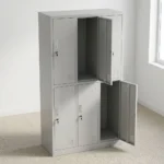 6-door steel storage locker cabinet featuring a light grey powder-coated metal finish, six individual locking compartments arranged in a 3-column by 2-tier layout, key locks with keyrings, recessed vertical handles, ventilation louvers, and built-in label holders on each door.