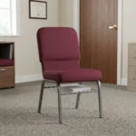 Fabric stackable church chair featuring plush burgundy fabric upholstery with a padded rectangular backrest and waterfall seat design, an armless ergonomic profile, an under-seat metal wire book rack, and a durable silver powder-coated steel frame with protective floor glides.