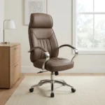 Brown leather swivel office chair featuring rich brown leatherette upholstery with vertical channel stitching, an ergonomic high-back profile with integrated headrest padding, polished metal loop armrests with padded leatherette arm caps, a pneumatic height-adjustment lever with tilt-tension mechanism, and a polished chrome five-star swivel base on dual-wheel casters.