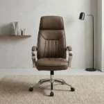 Brown leather swivel office chair featuring rich brown leatherette upholstery with vertical channel stitching, an ergonomic high-back profile with integrated headrest padding, polished metal loop armrests with padded leatherette arm caps, a pneumatic height-adjustment lever with tilt-tension mechanism, and a polished chrome five-star swivel base on dual-wheel casters.