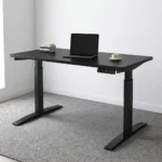 120cm black electric adjustable table featuring a smooth black laminate desktop, an under-desk digital smart control panel, a motor-driven motorized lifting system, and dual telescoping black powder-coated steel T-frame legs with low-profile flat feet.