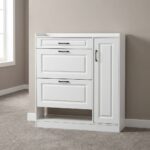 White modern shoe rack featuring crisp white engineered wood with traditional recessed panel detailing, a top utility pull-out drawer, two tilt-down shoe compartment drawers, a tall side cabinet door with slim black handles, an open lower shoe storage shelf, and a flat plinth base.