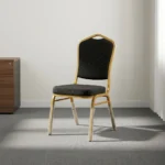 Black stackable event chair featuring black patterned fabric upholstery with gold dot accents on a crown-back backrest and padded seat cushion, an armless space-saving frame, and a durable gold powder-coated aluminum steel tubular frame base with stack bumpers and floor glides.