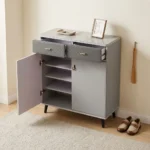 Modern bucket flip shoe rack featuring a faux grey marble top surface, two top grey lockable drawers with gold pull handles, lower dual white hinged doors opening to multi-tiered shoe storage shelves, and elevated dark tapered wooden legs.