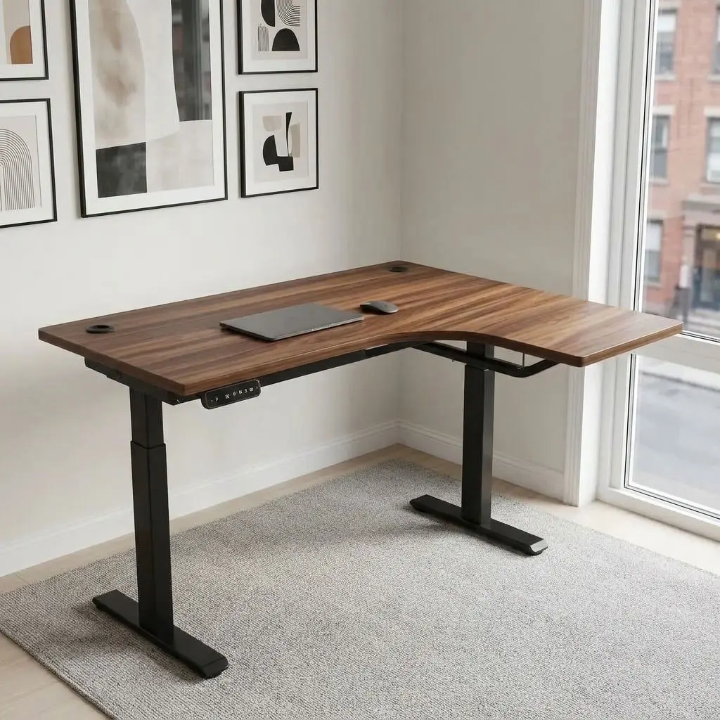 Curved electric adjustable table featuring an L-shaped curved walnut wood-grain laminate desktop with dual cable management grommets, an under-desk digital LED control handset with height presets, motor-driven sit-stand elevation mechanisms, and a heavy-duty black powder-coated steel dual-leg lifting frame with wide T-style foot bases.