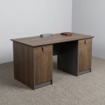 Rectangular 1.2m office table featuring a walnut wood-grain laminate desktop with a central flip-top cable outlet box, twin pedestal side cabinets with grey-framed top drawers and lower storage doors, and a full modesty panel floor-standing pedestal base.