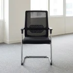Mid-back cantilever waiting chair featuring a breathable black mesh mid-back rest with an integrated geometric pattern lumbar support band, a cushioned black fabric seat, fixed T-shaped armrests with black arm pads, and a continuous tubular chrome cantilever frame base with protective floor glides.